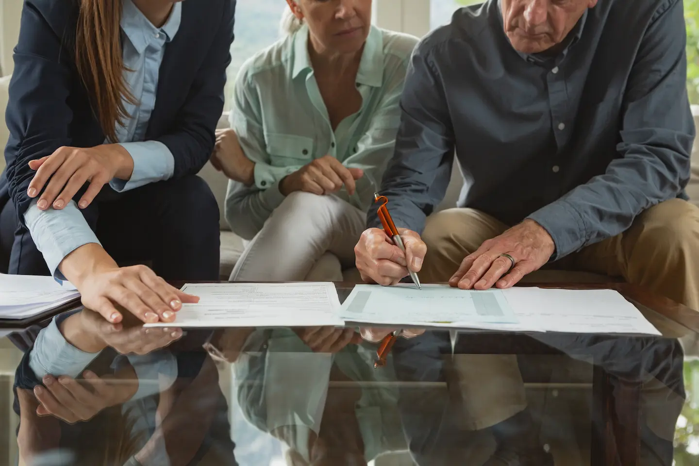 Seniors signing documents at a table — Estate Planning services