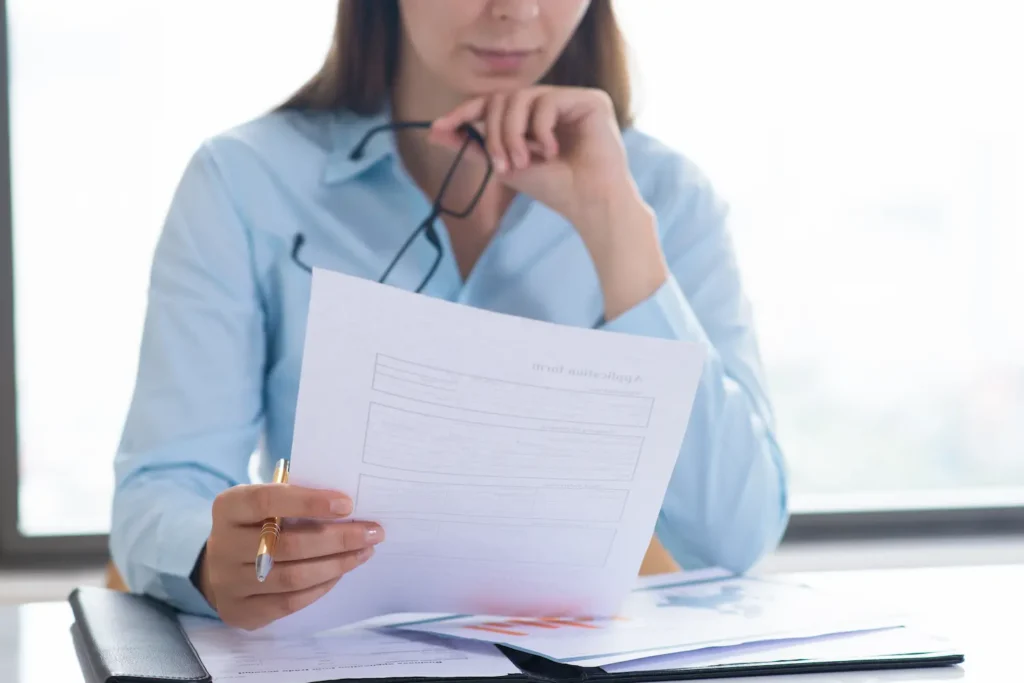closeup-woman-holding-reading-document (1)